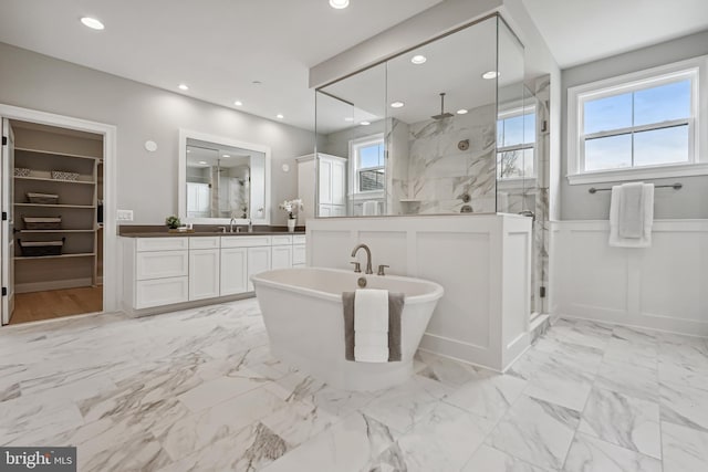 bathroom with separate shower and tub, vanity, and plenty of natural light