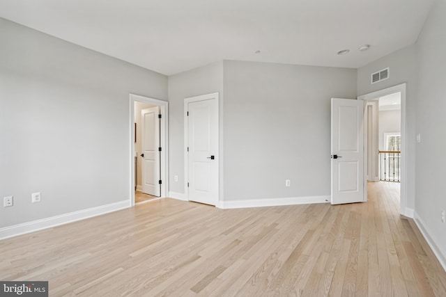 empty room with light hardwood / wood-style floors