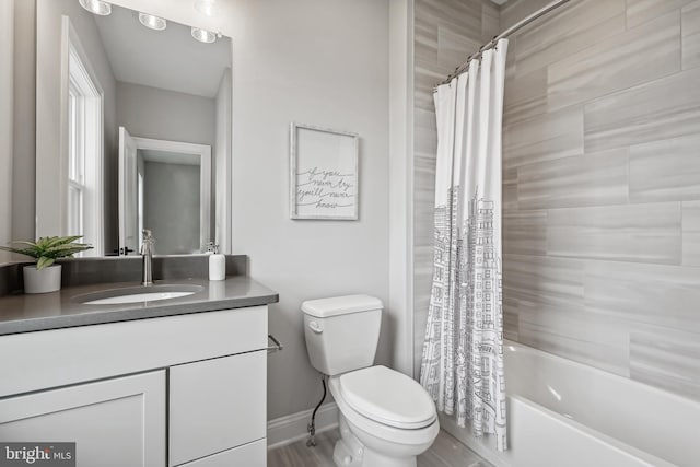 full bathroom with shower / bath combo with shower curtain, toilet, and vanity