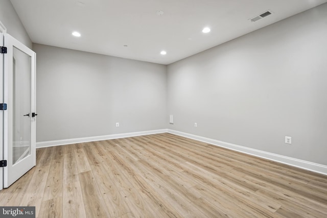 unfurnished room with light hardwood / wood-style floors