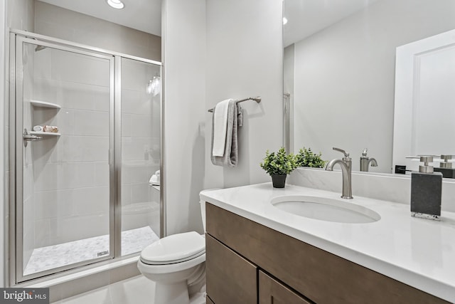 bathroom with toilet, tile patterned flooring, an enclosed shower, and vanity