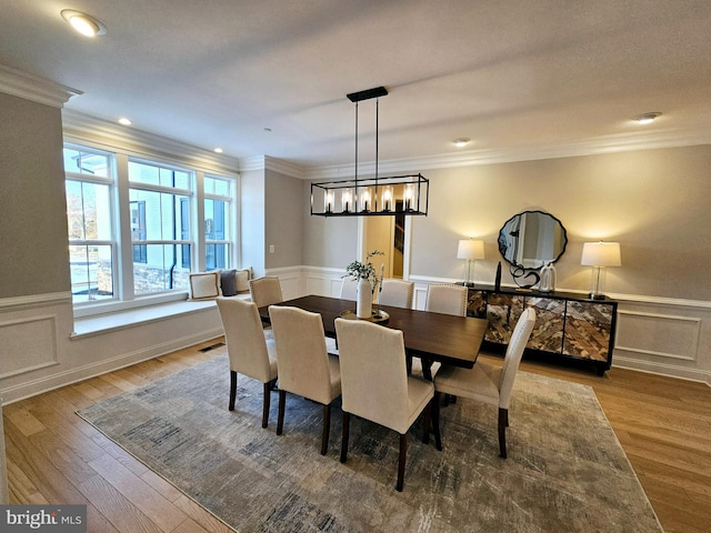 dining room featuring crown molding and hardwood / wood-style floors