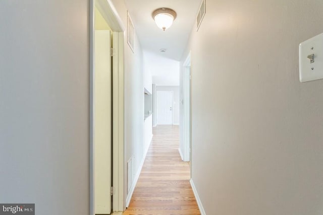 hall with light hardwood / wood-style floors