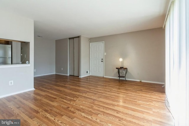 unfurnished living room with hardwood / wood-style flooring