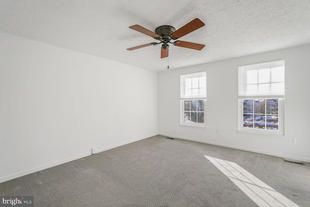 unfurnished room featuring a textured ceiling, ceiling fan, and carpet flooring