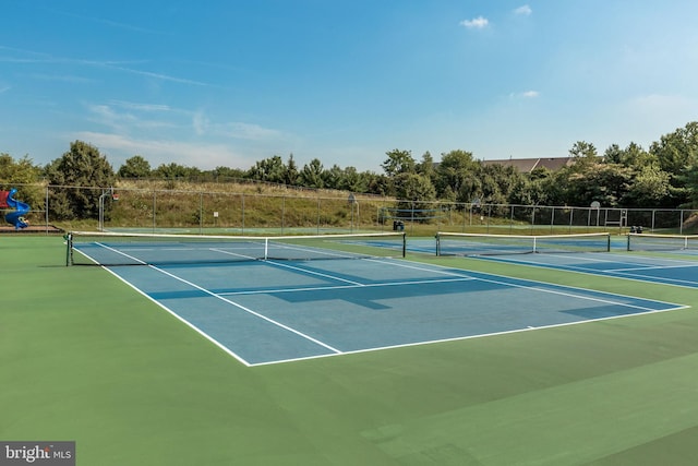 view of sport court with a playground