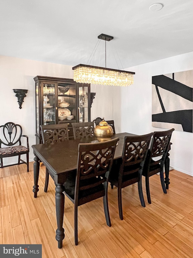 dining area with a chandelier and hardwood / wood-style flooring