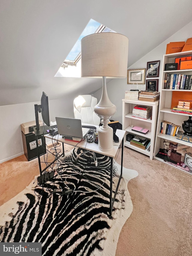 carpeted home office with vaulted ceiling