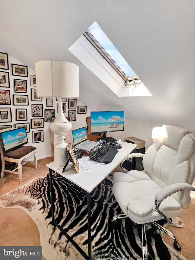 carpeted office with lofted ceiling with skylight