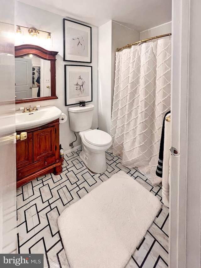 bathroom with toilet and vanity