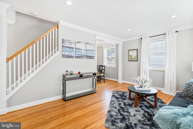 living room featuring crown molding and wood-type flooring