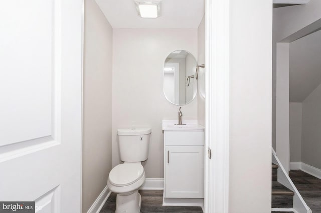 bathroom featuring hardwood / wood-style floors, vanity, and toilet