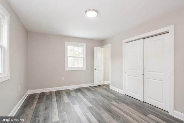 unfurnished bedroom with light hardwood / wood-style floors and a closet