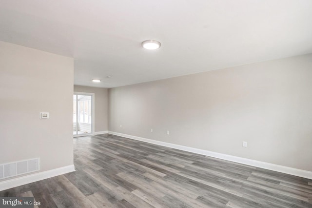 unfurnished room featuring dark hardwood / wood-style floors