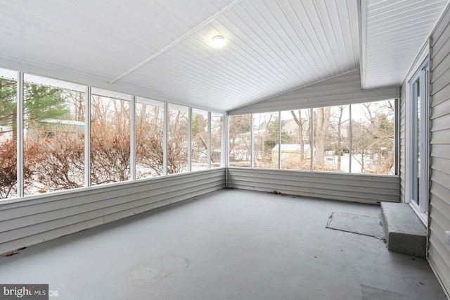 unfurnished sunroom featuring vaulted ceiling