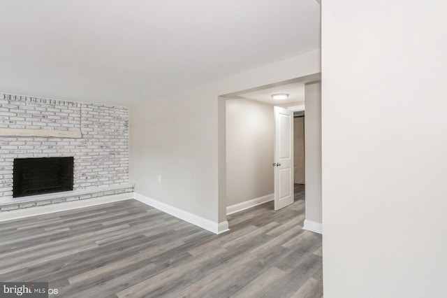 unfurnished living room with hardwood / wood-style floors and a fireplace