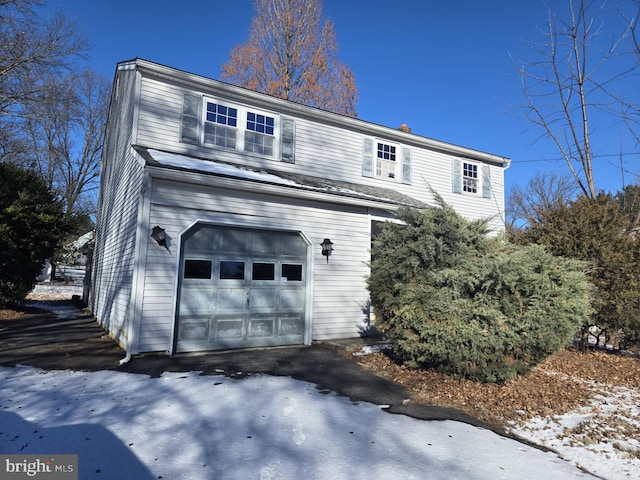 back of property with a garage