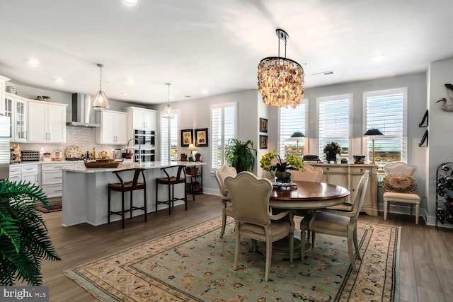 dining area featuring a chandelier and dark hardwood / wood-style floors