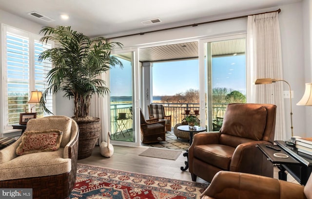 sitting room featuring hardwood / wood-style floors and a healthy amount of sunlight