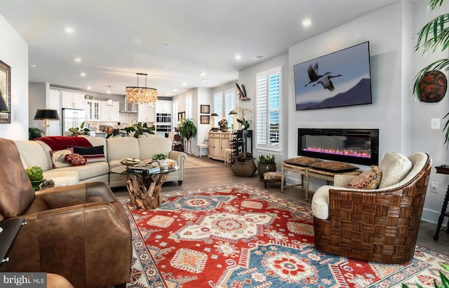 living room with a notable chandelier and hardwood / wood-style floors