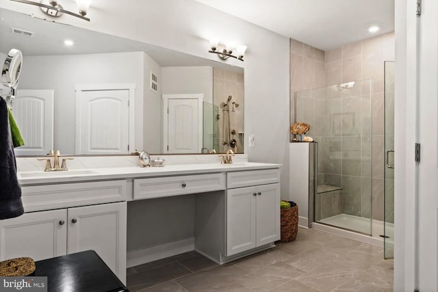 bathroom with vanity and a shower with shower door