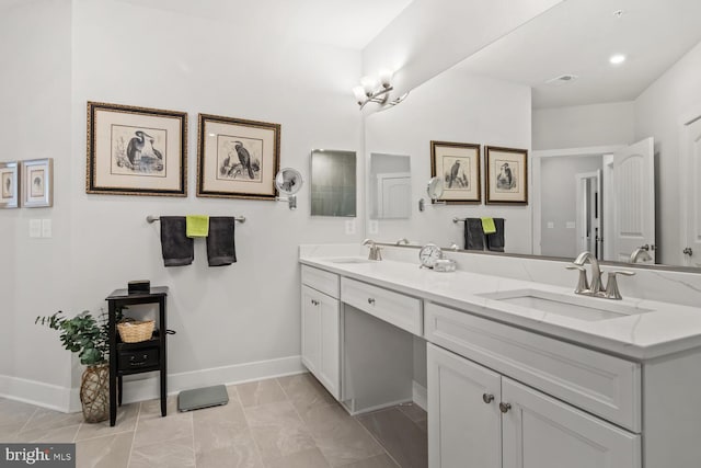 bathroom with a notable chandelier, tile patterned flooring, and vanity