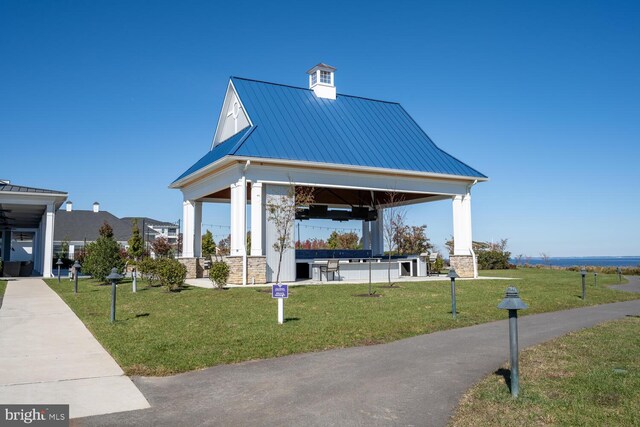 view of home's community with a lawn and a gazebo