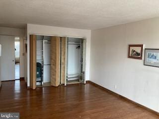 spare room featuring dark wood-type flooring