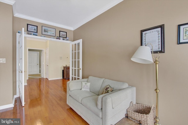 sitting room with hardwood / wood-style flooring, ornamental molding, and french doors