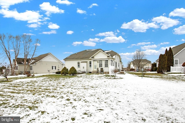 view of snow covered rear of property