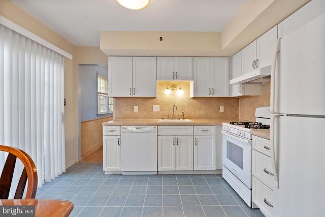 kitchen featuring white cabinets, sink, and white appliances