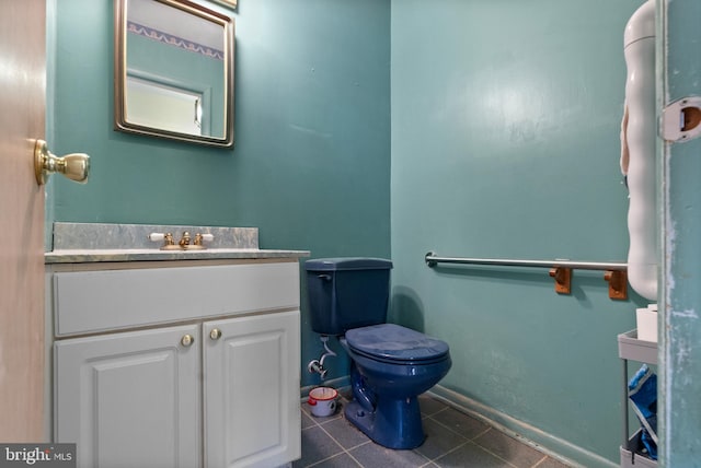 bathroom featuring toilet, tile patterned flooring, and vanity