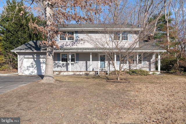 view of property featuring covered porch and a garage