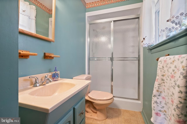 bathroom with an enclosed shower, vanity, and toilet