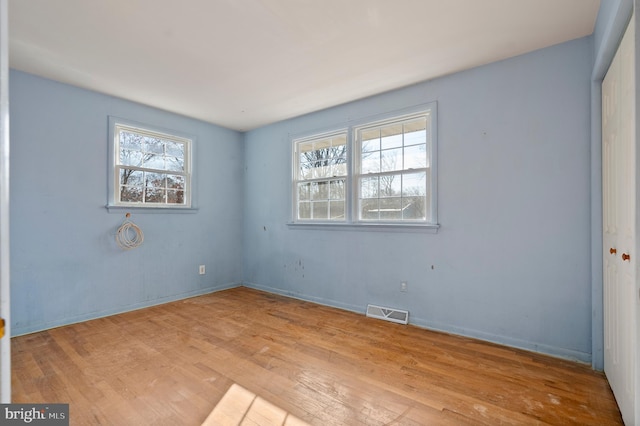 spare room featuring light wood-type flooring