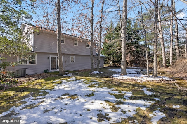 snow covered property featuring central AC unit