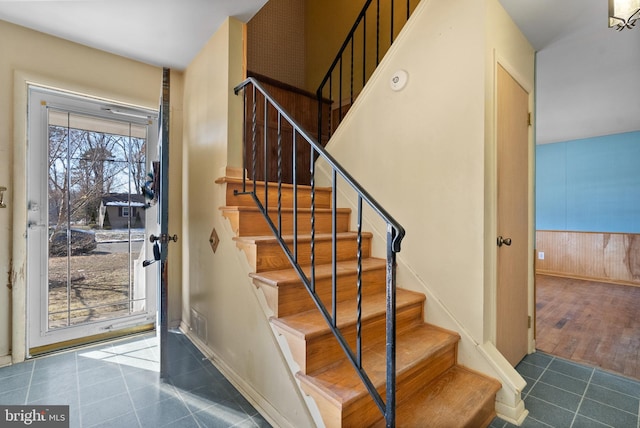 stairway with tile patterned floors