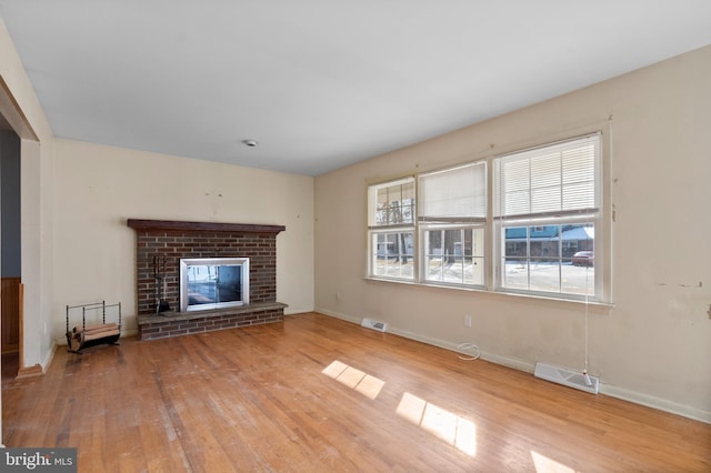 unfurnished living room with light hardwood / wood-style floors and a fireplace