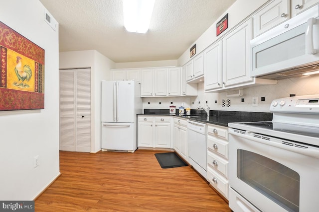 kitchen with sink, white appliances, white cabinetry, light hardwood / wood-style floors, and a textured ceiling