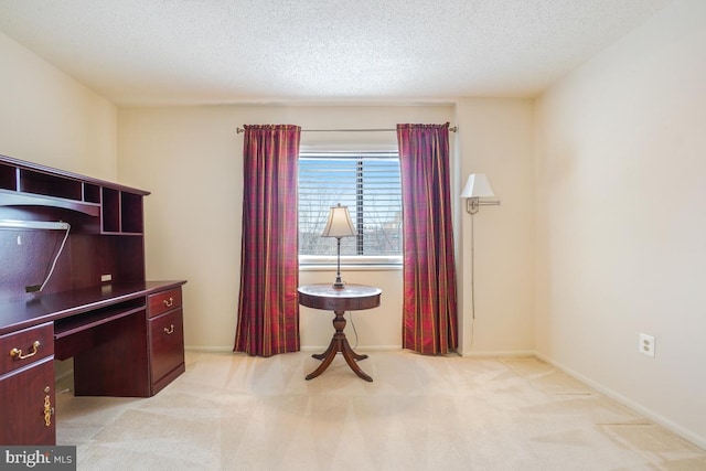 office area with light carpet and a textured ceiling