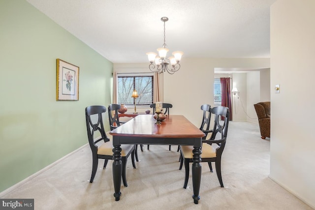 carpeted dining space with a notable chandelier