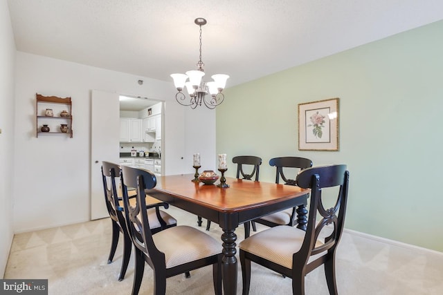 carpeted dining room featuring an inviting chandelier