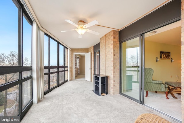 sunroom featuring ceiling fan