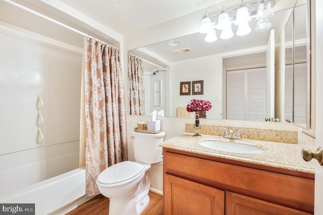 full bathroom featuring vanity, hardwood / wood-style floors, toilet, and shower / bathtub combination with curtain