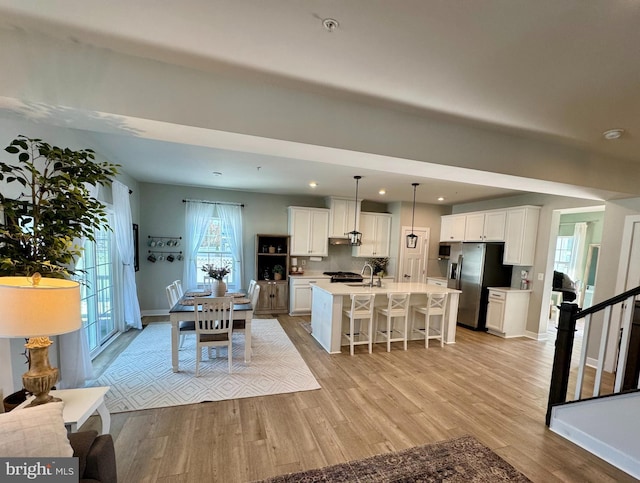 dining space with light hardwood / wood-style flooring and sink