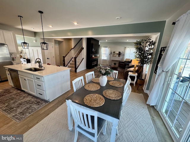 dining space with sink and hardwood / wood-style floors