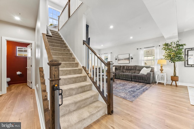 stairs featuring hardwood / wood-style flooring