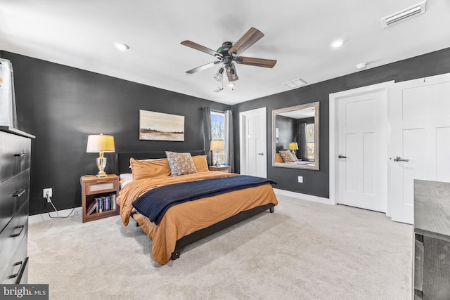 bedroom featuring light colored carpet and ceiling fan