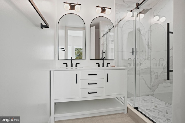 bathroom with a shower with door and vanity