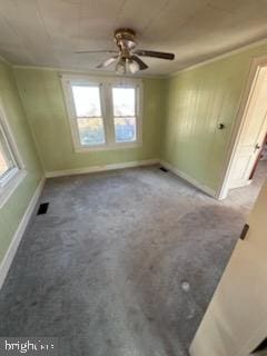 spare room with ceiling fan, carpet flooring, and ornamental molding